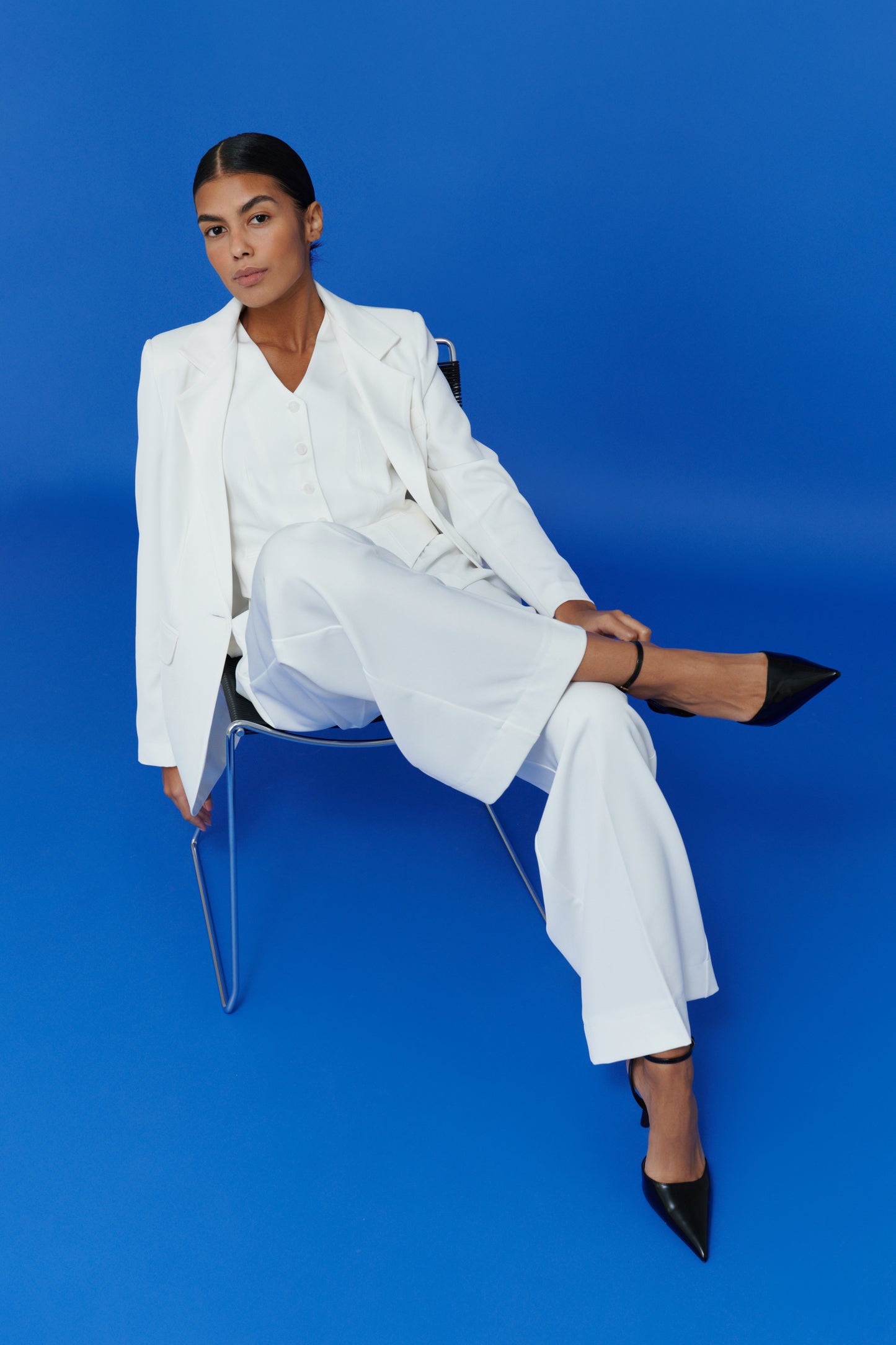 Classic tailored white vest styled with matching pants