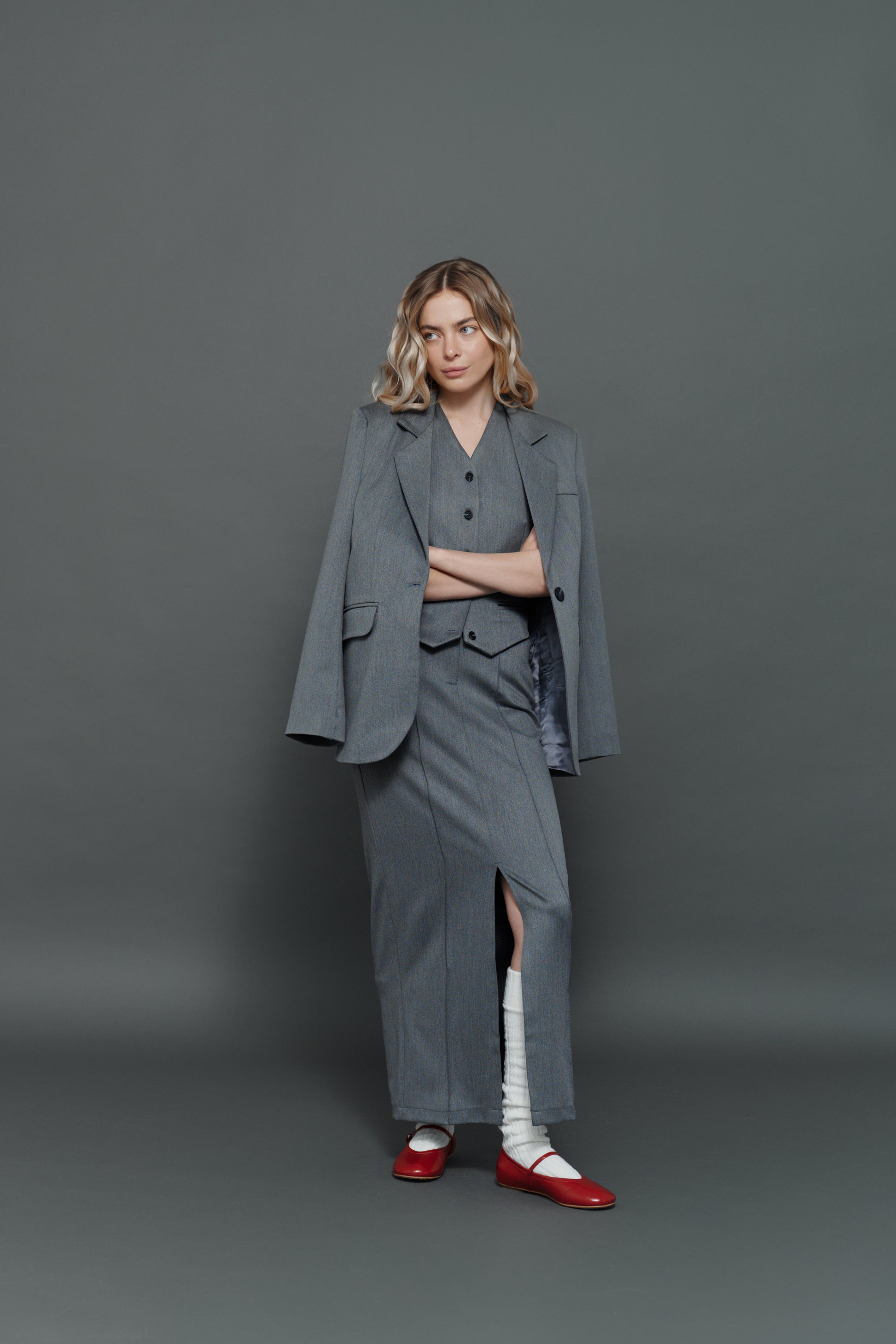 Model wearing gray skirt with matching gray blazer, professional co-ord outfit