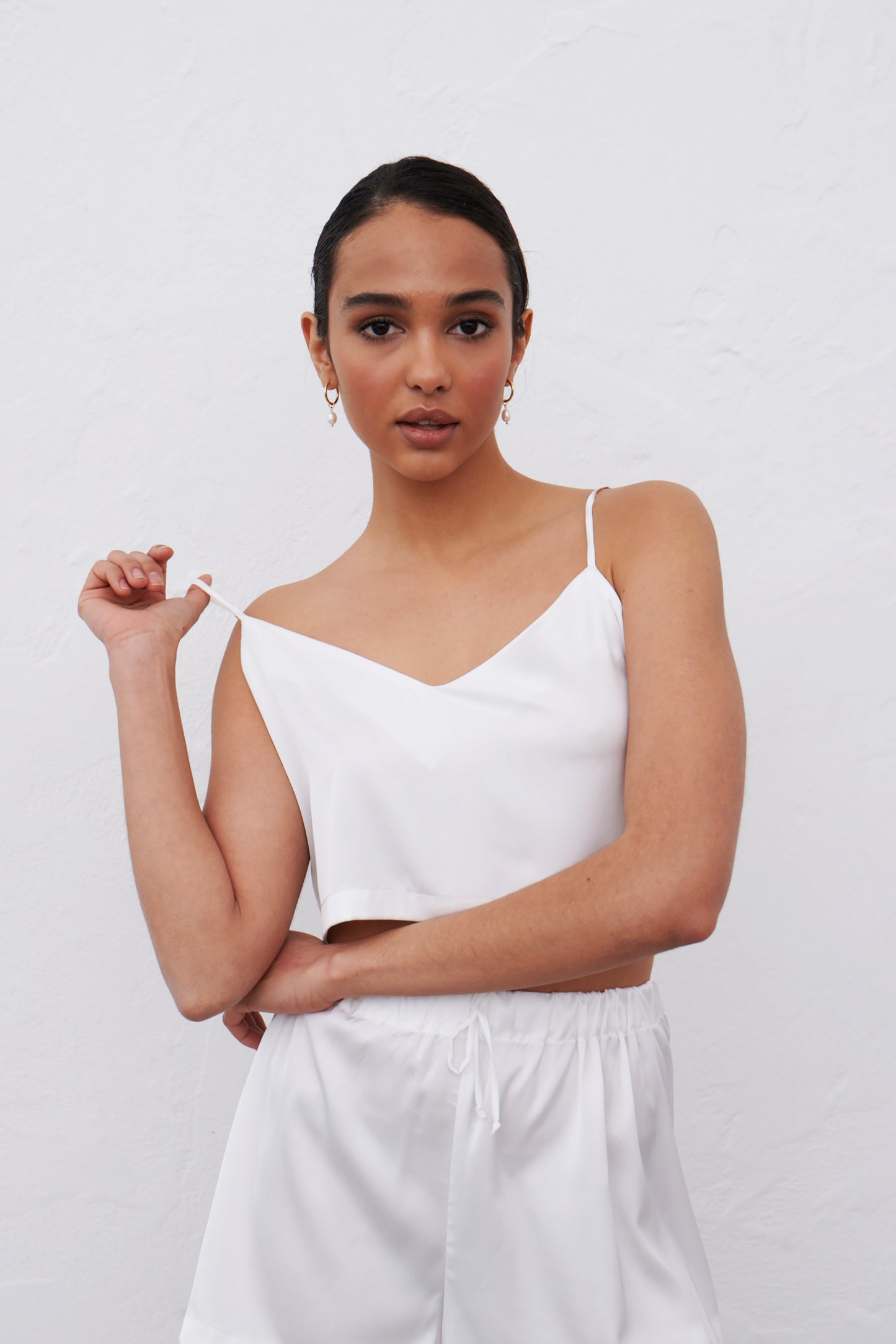 White satin pajamas set with delicate straps and shorts