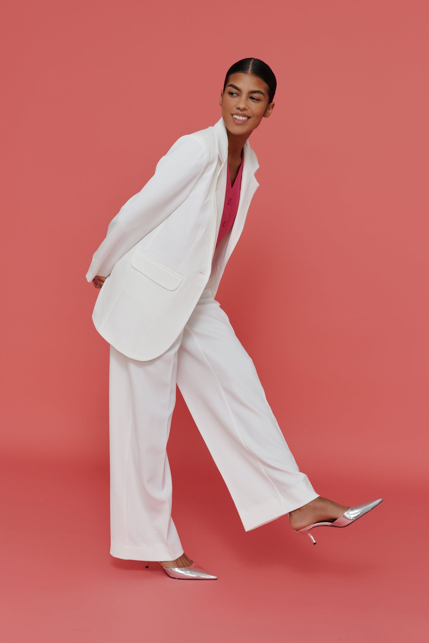 woman styling white palazzo pants with blazer