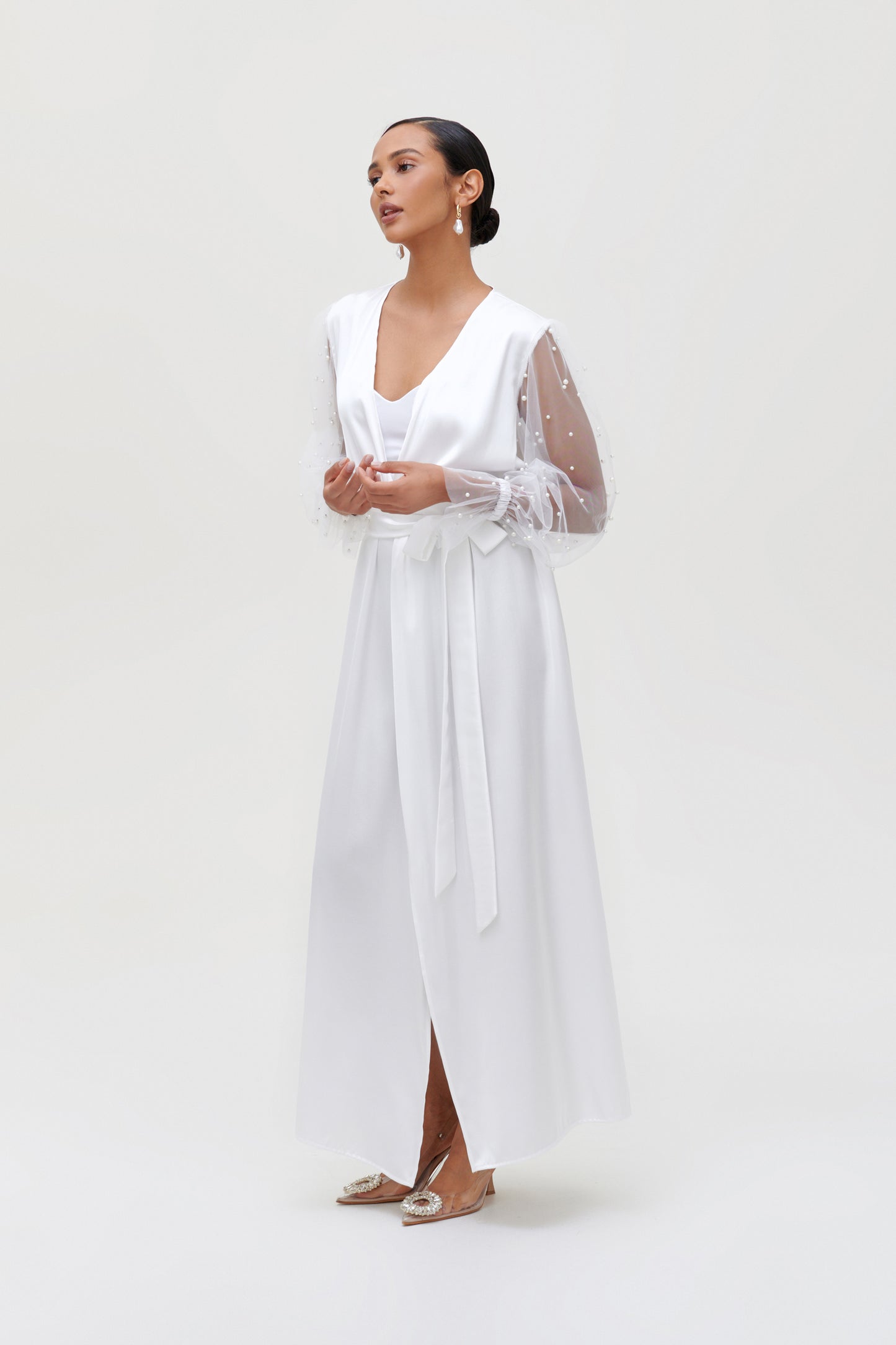 Elegant white pearl bridal robe with satin fabric and pearl-adorned sleeves, perfect for a bridal morning photoshoot.