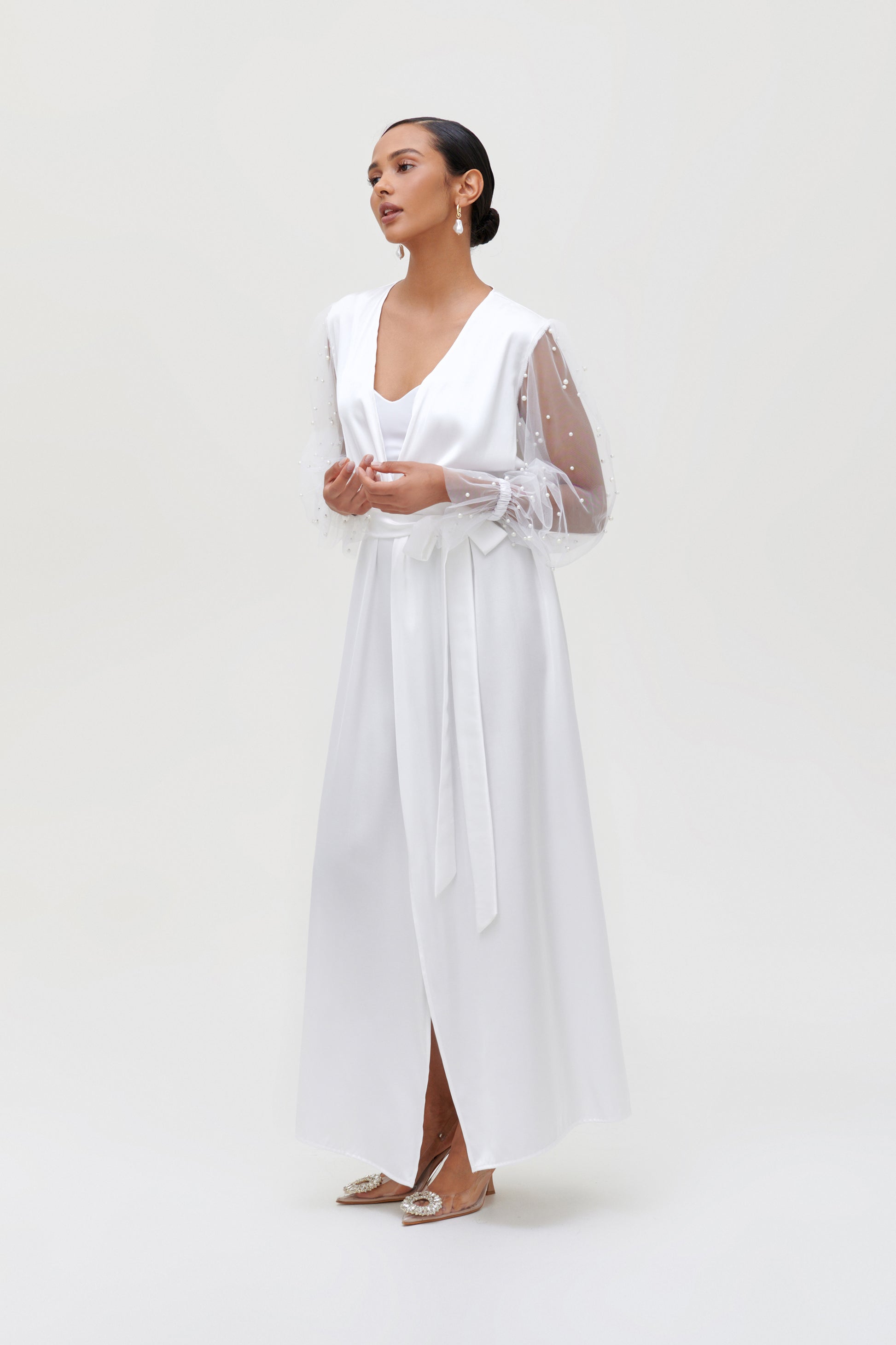 Elegant white pearl bridal robe with satin fabric and pearl-adorned sleeves, perfect for a bridal morning photoshoot.